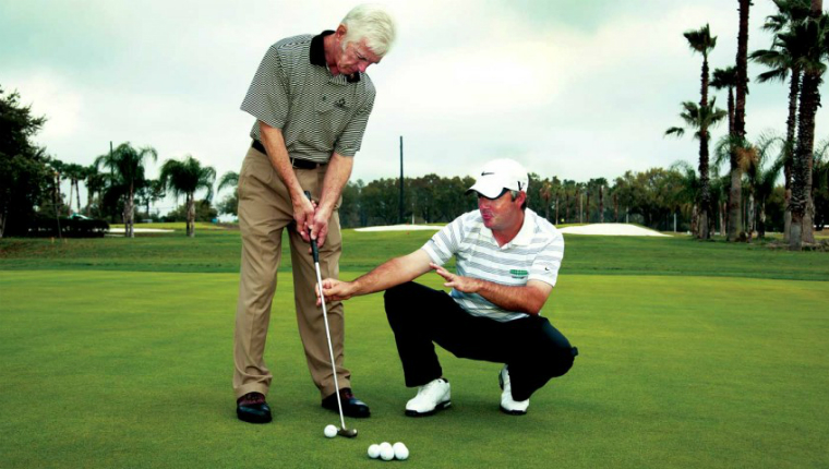 a man getting coached on golf