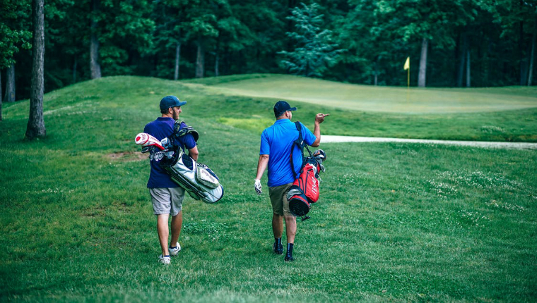 men walking across a golf course