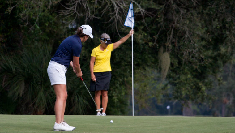 women playing golf